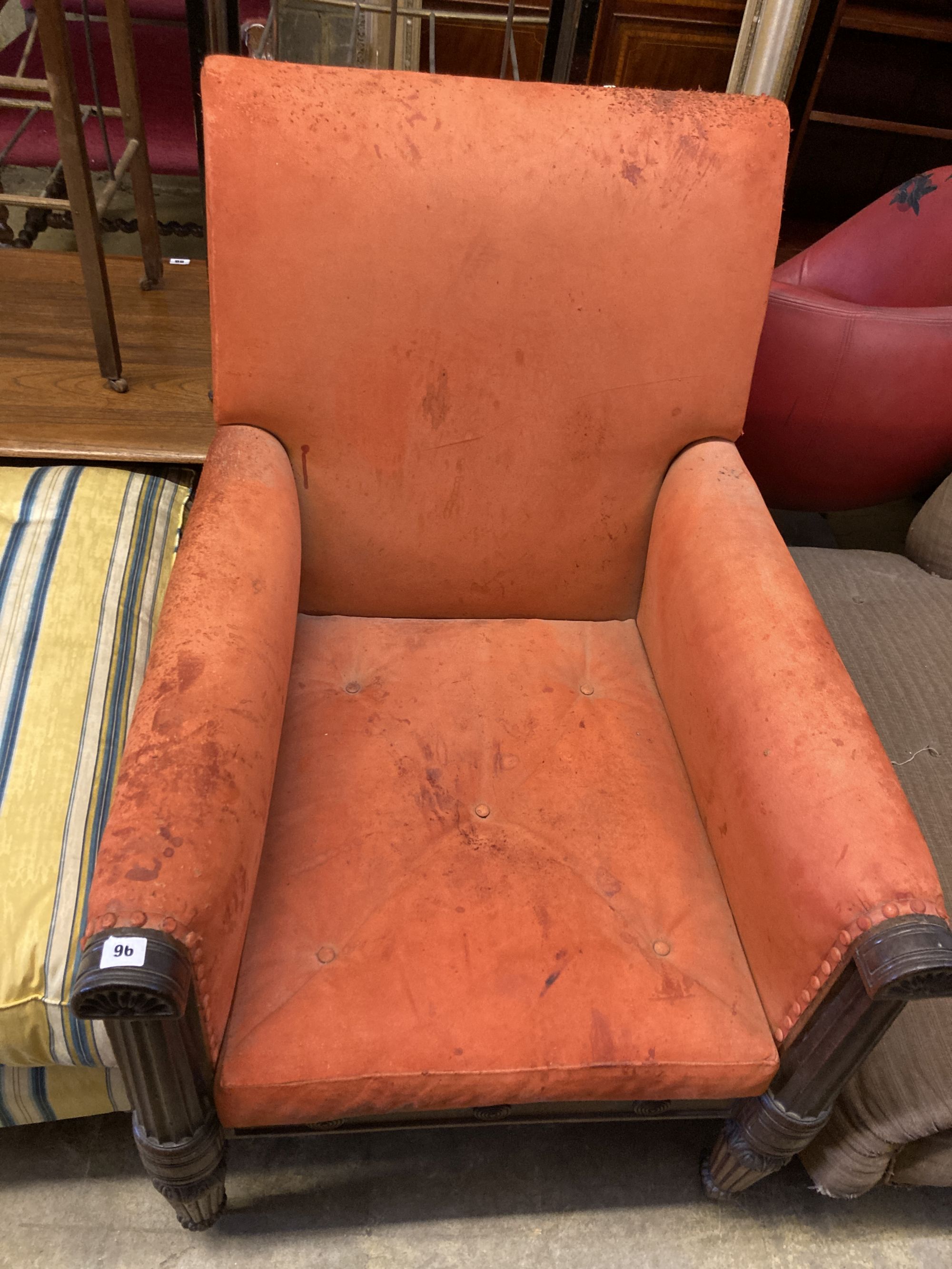 A George IV carved mahogany library armchair upholstered in faded red leather, width 70cm, depth 80cm, height 100cm